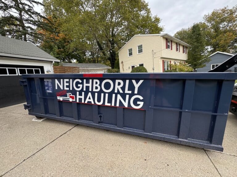 17 yard Neighborly Hauling roll-off dumpster placed on a residential driveway in West Michigan.