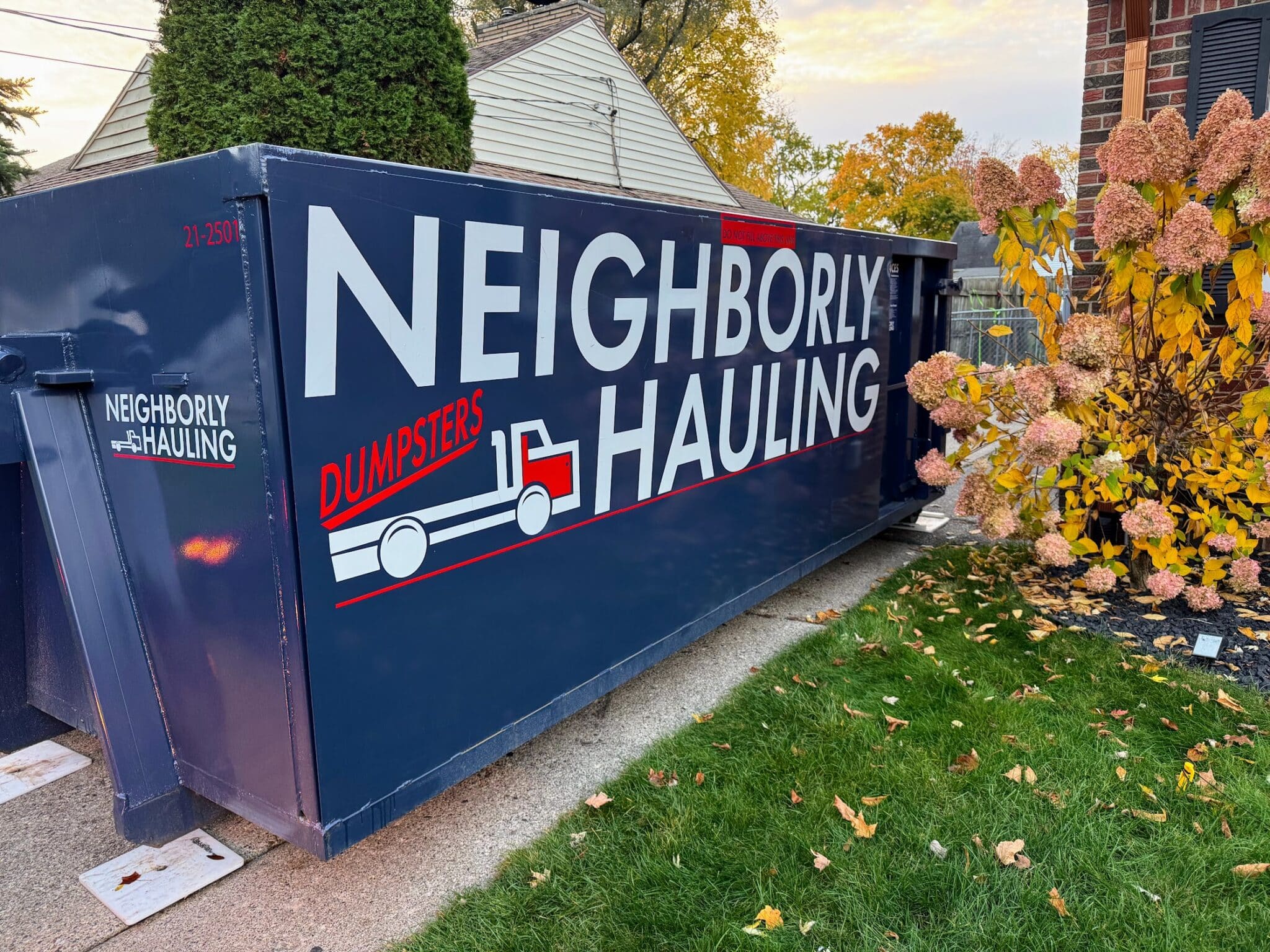 21 yard dumpster rental in a Grand Rapids residential driveway — Neighborly Hauling