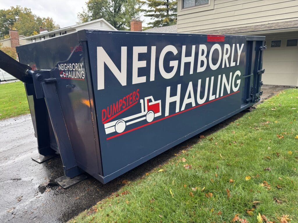 21 yard dumpster rental by Neighborly Hauling in West Michigan with driveway protection for residential and construction projects