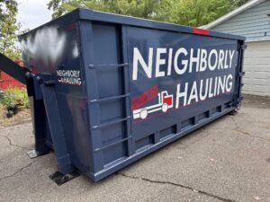 25 yard dumpster rental by Neighborly Hauling in West Michigan placed with driveway protection for large cleanouts and construction projects