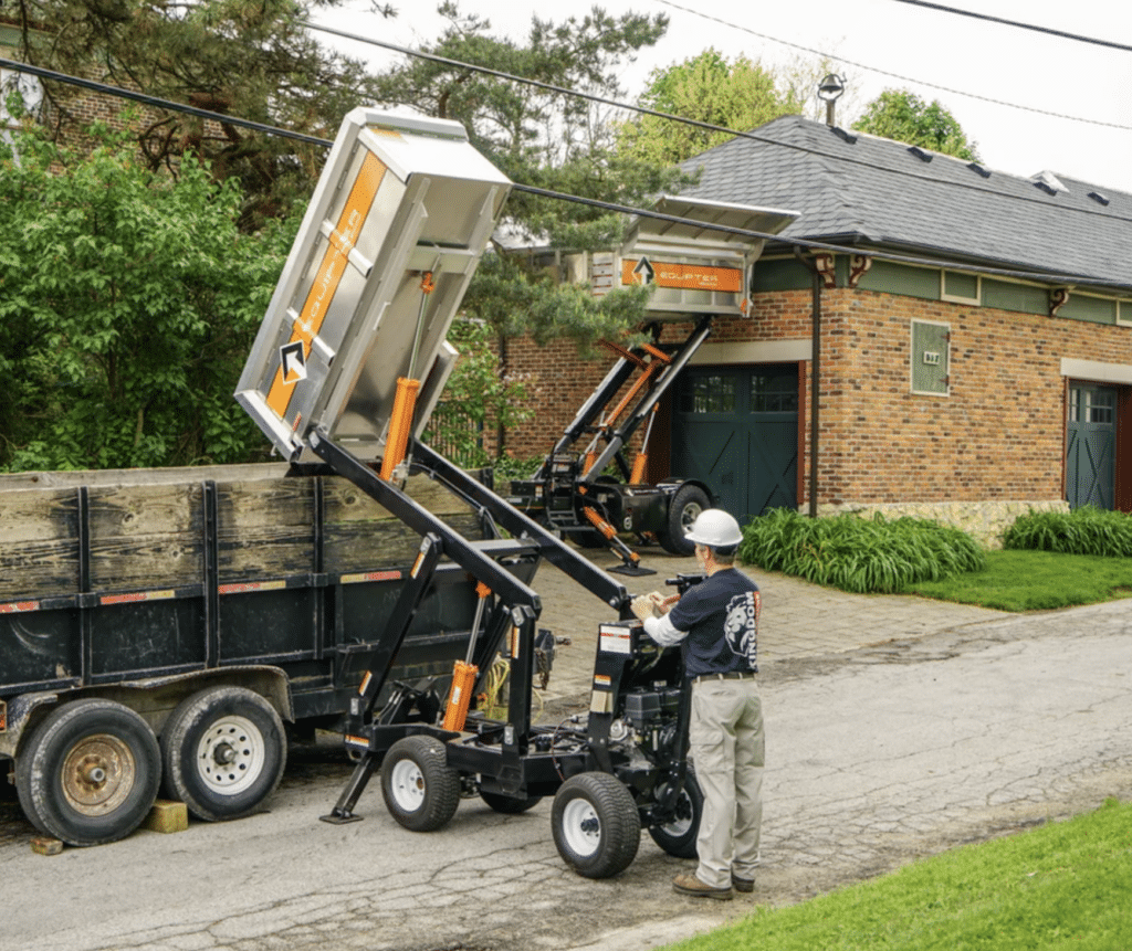 Equipter 2000 debris loader safely loading roofing material into a dumpster on a residential jobsite in West Michigan