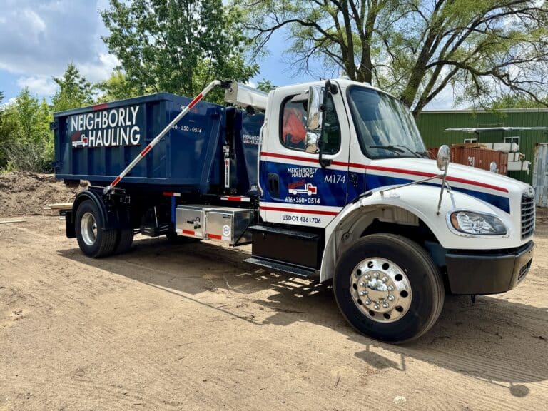 West Michigan dumpster rental roll off truck delivering a dumpster container.