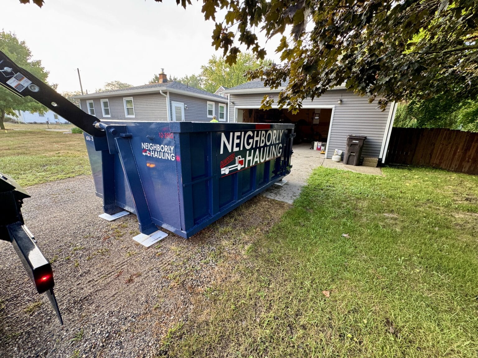 Professional roll-off dumpster placement service in West Michigan residential area